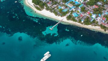 Aerial photography of a ship leaving its port with the [urpose of going and finding new adventures